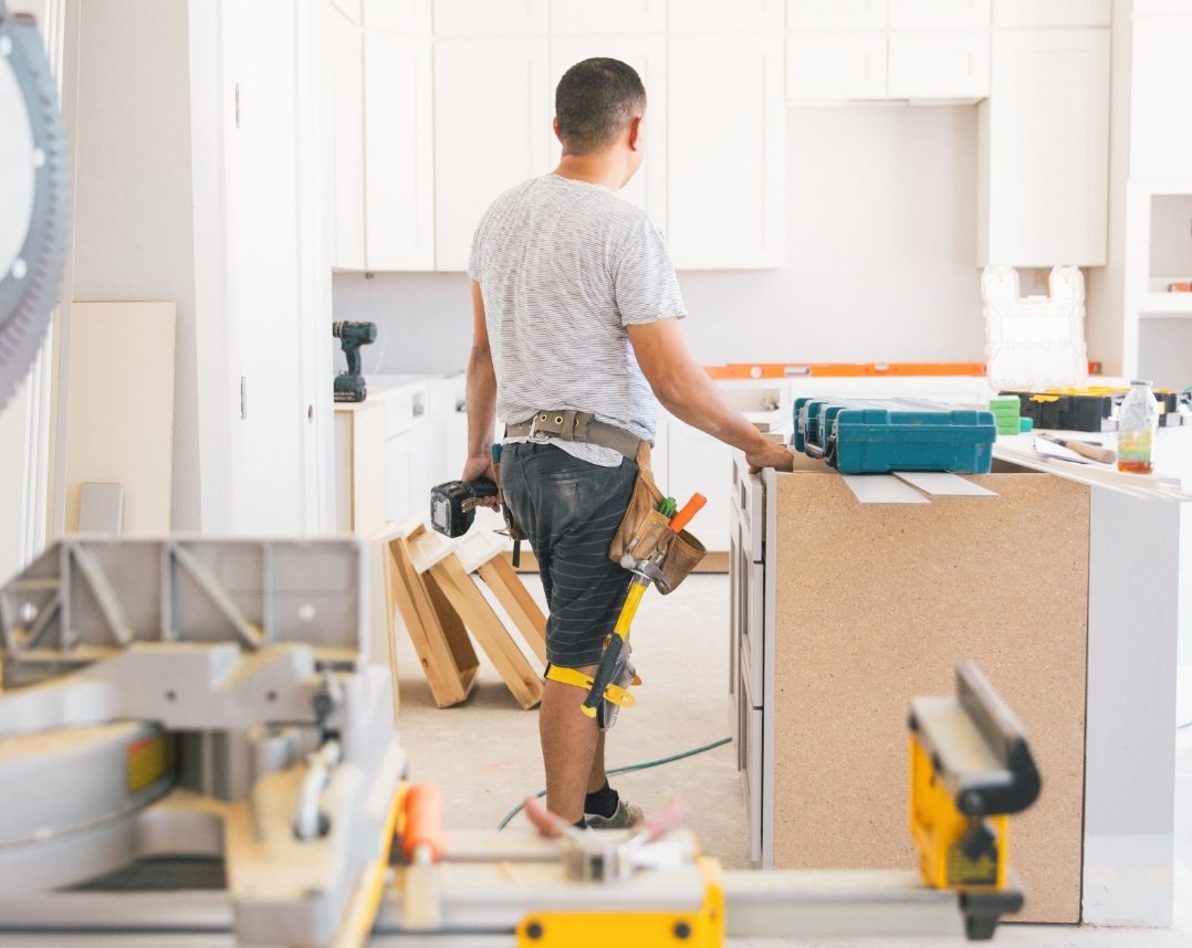 Contractor installing new kitchen cabinets