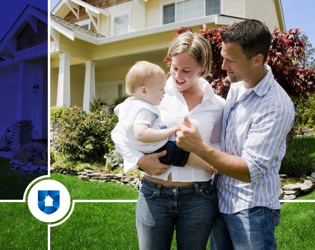Young family standing in front of a yellow home