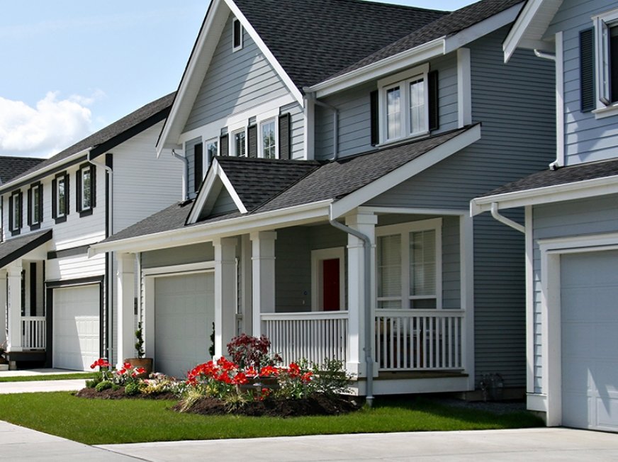 2-story grey home with clean yard and large patio