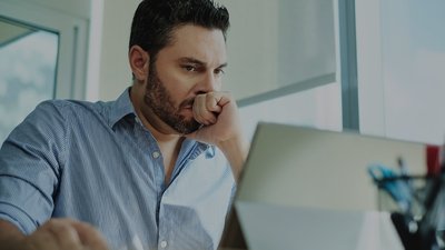 Man looking at laptop concerned