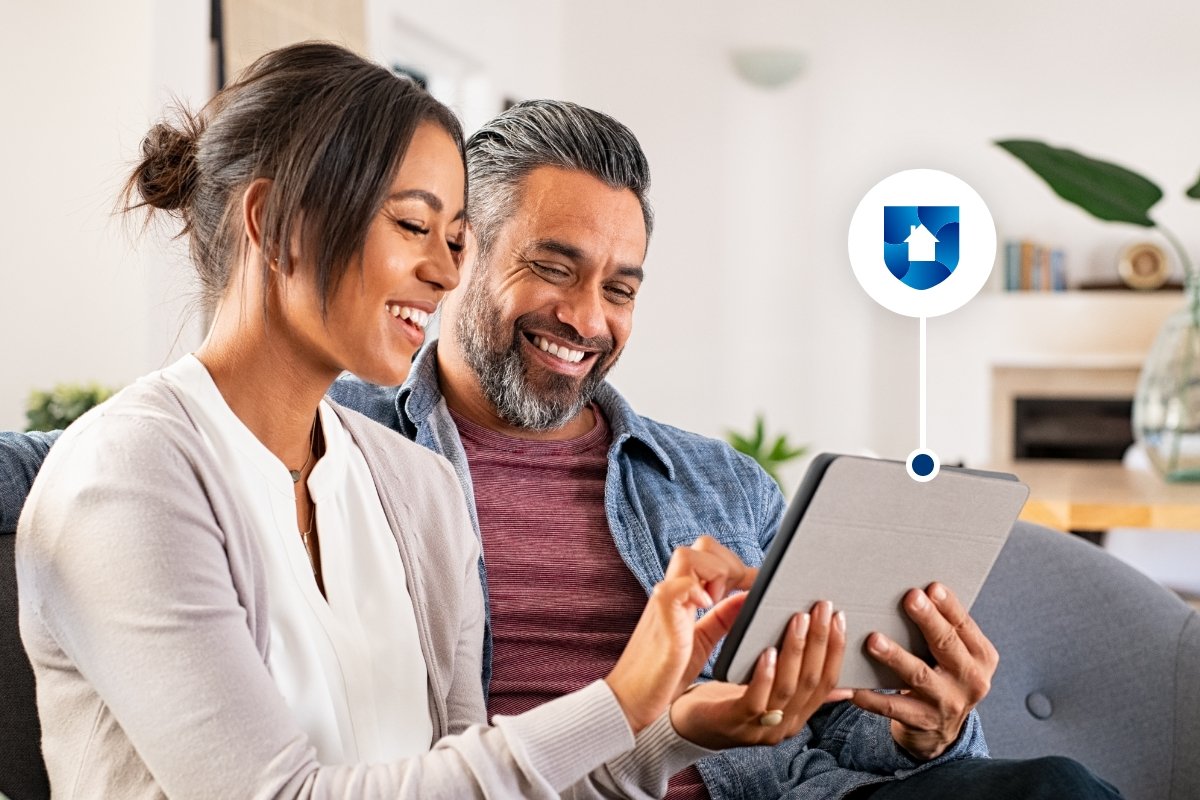 A happy, smiling couple using a tablet